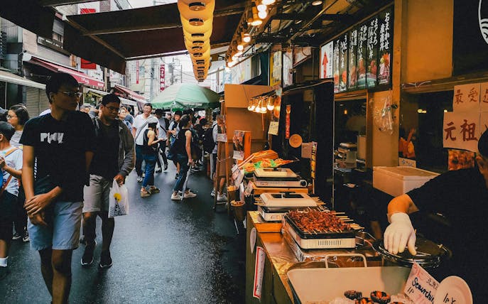 Street food market bustling with people during Tokyo Night Tour.