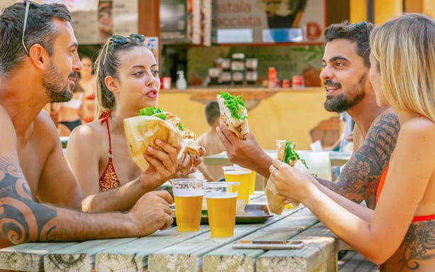 Group enjoying food and drinks at Parco Cavour Water Park.