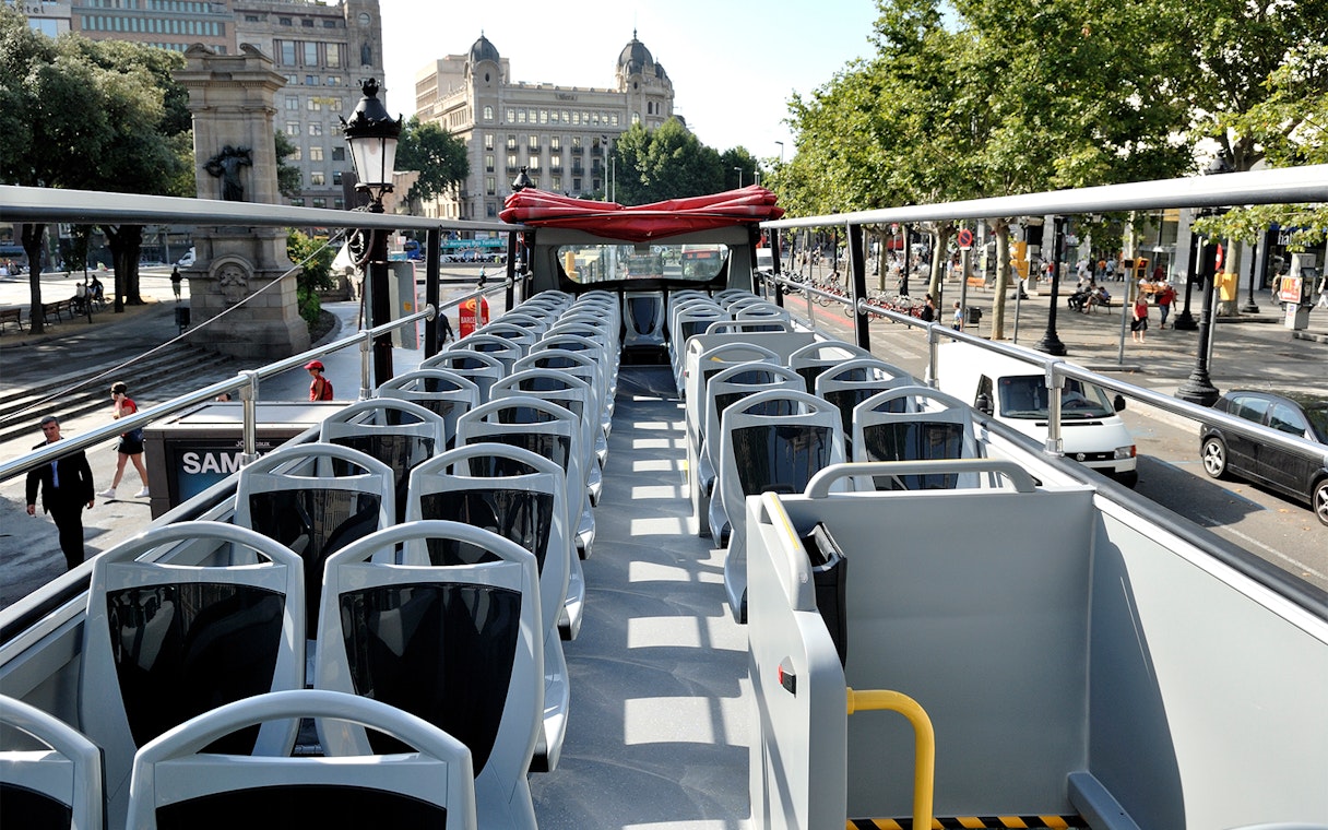 Open-top bus seats on Barcelona City Tour route.