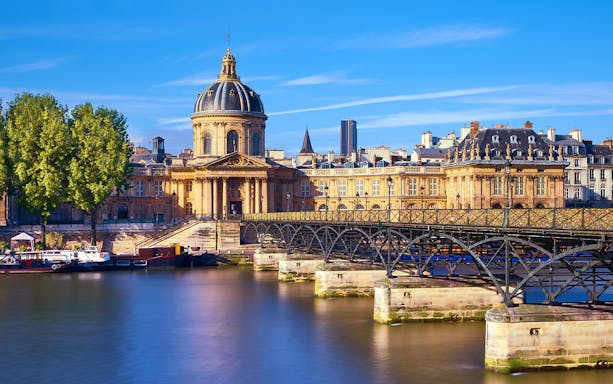 Pont des Arts bridge and Institut de France in Paris, featured in Emily in Paris tour.