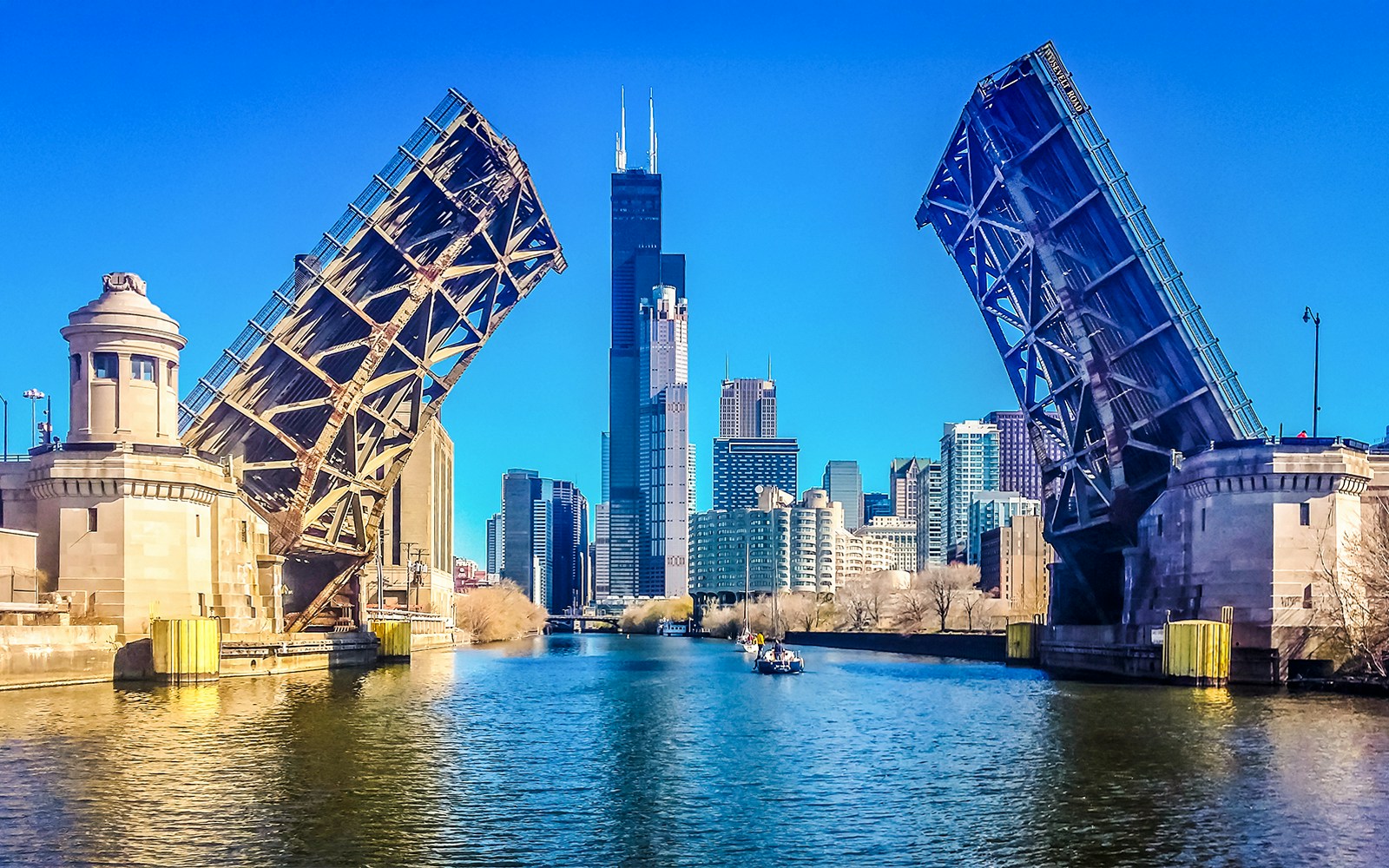 Open drawbridge over Southside River with Chicago skyline in the background.