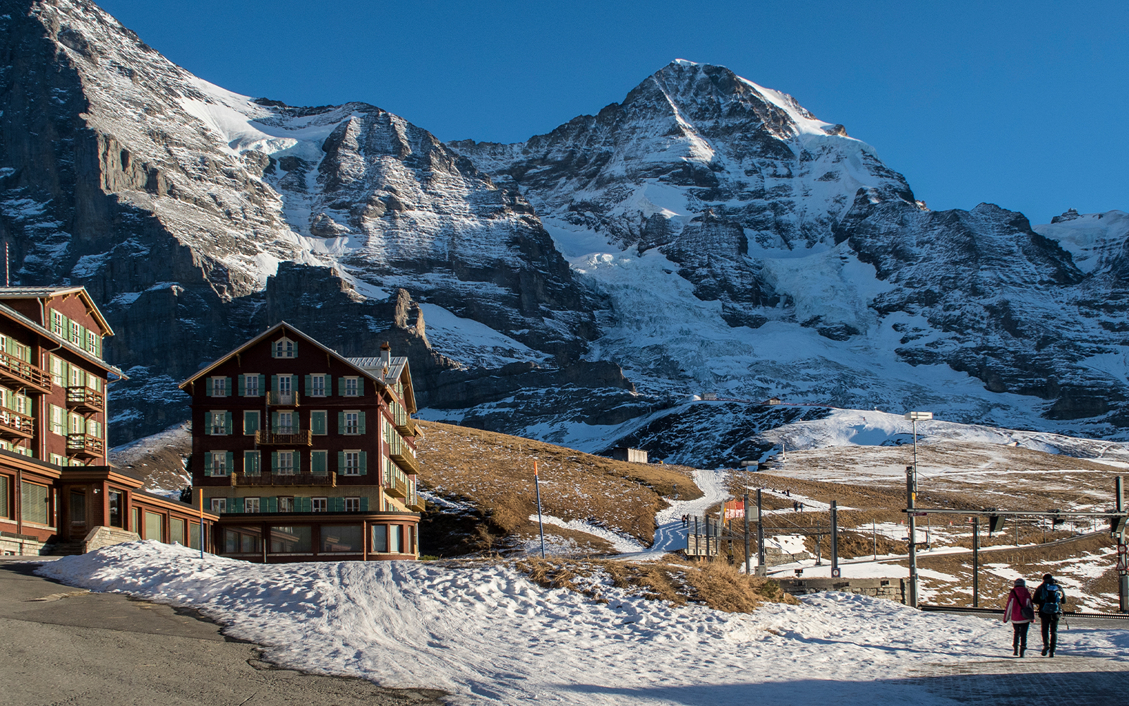 Jungfraujoch winter landscape at sunset with snow-covered peaks and vibrant sky.