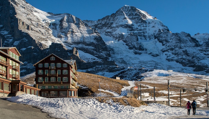 Jungfraujoch winter landscape at sunset with snow-covered peaks and vibrant sky.