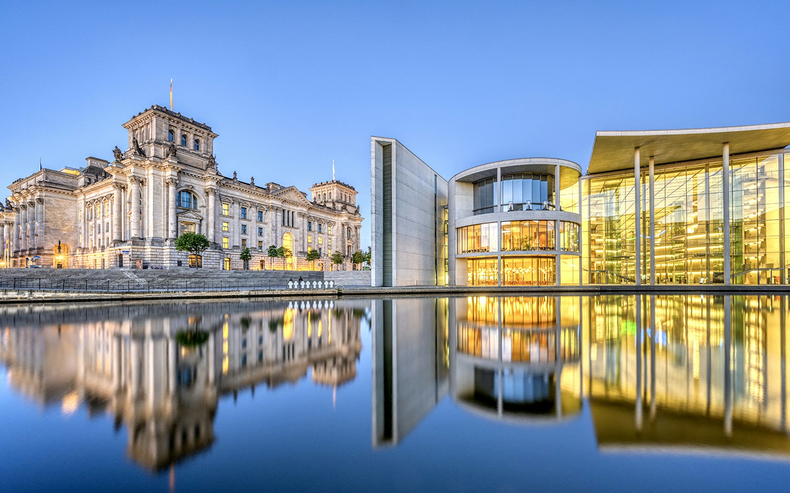 Reichstag and Paul-Loebe-Haus by the Spree River in Berlin at dusk.