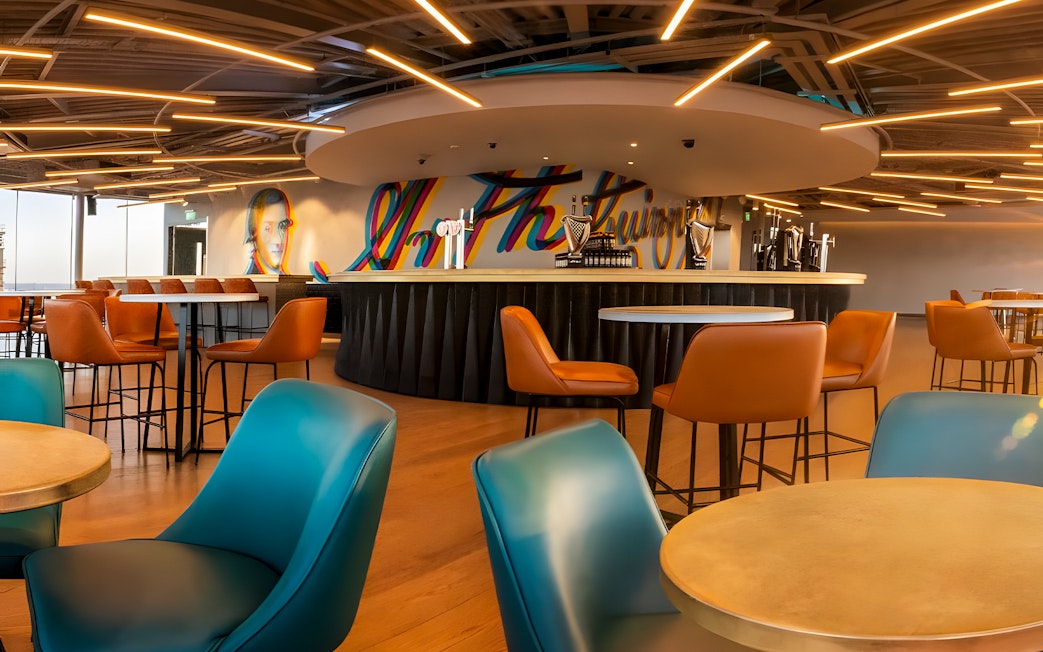 Gravity Bar interior at Guinness Storehouse Dublin with colorful mural and seating.