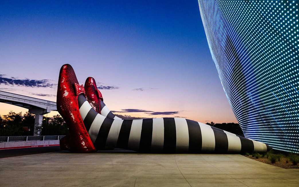 Giant striped legs with red shoes at Sphere, Wizard of Oz theme.