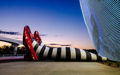 Giant striped legs with red shoes at Sphere, Wizard of Oz theme.