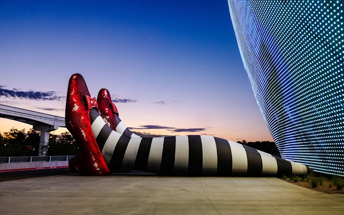 Giant striped legs with red shoes at Sphere, Wizard of Oz theme.