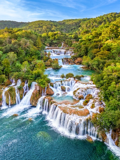 Waterfalls cascading through lush greenery at Krka National Park, Croatia.