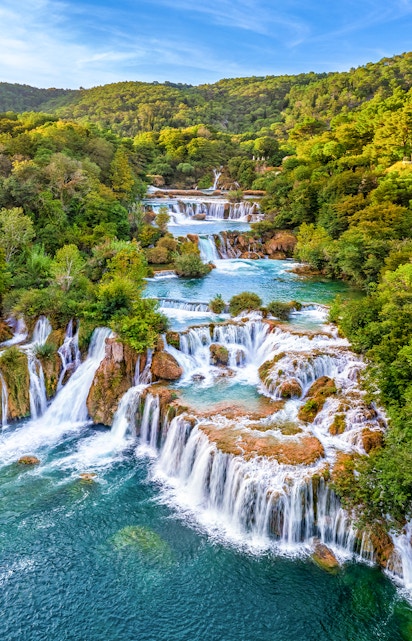 Waterfalls cascading through lush greenery at Krka National Park, Croatia.