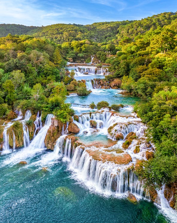 Waterfalls cascading through lush greenery at Krka National Park, Croatia.
