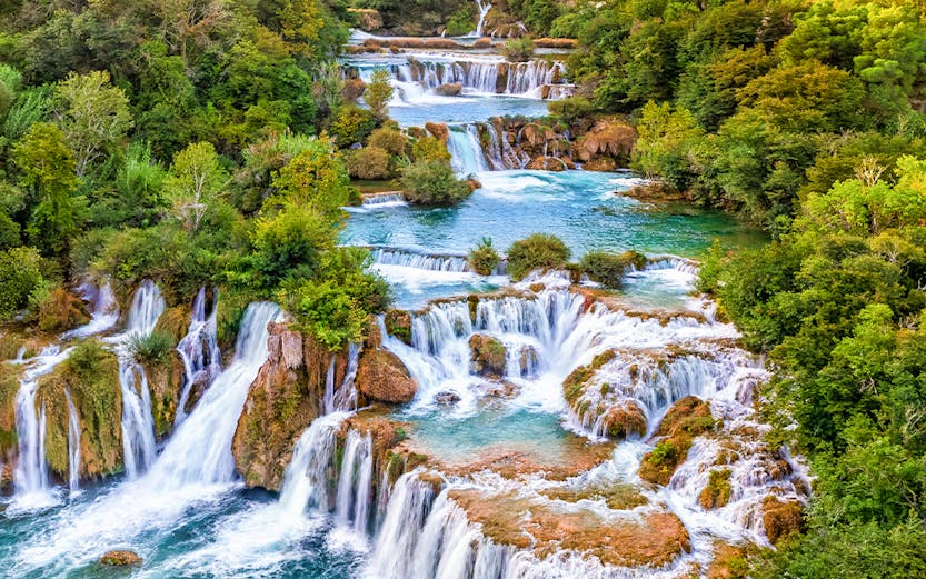 Waterfalls cascading through lush greenery at Krka National Park, Croatia.