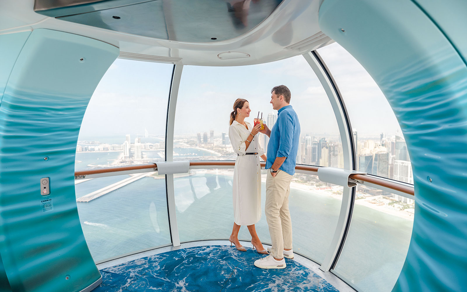Visitors enjoying views inside Ain Dubai observation cabin.
