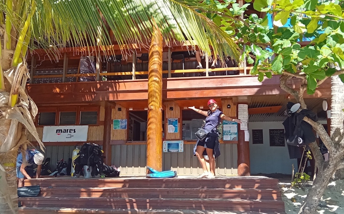 Tourist at dive shop entrance, Kuata Island, Fiji.