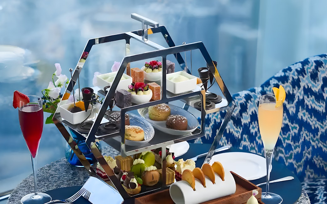 Afternoon tea set with pastries and drinks at At.mosphere Burj Khalifa, Dubai.