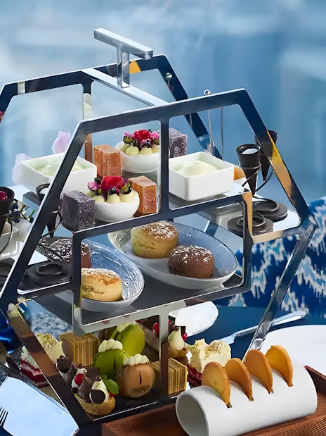 Afternoon tea set with pastries and drinks at At.mosphere Burj Khalifa, Dubai.