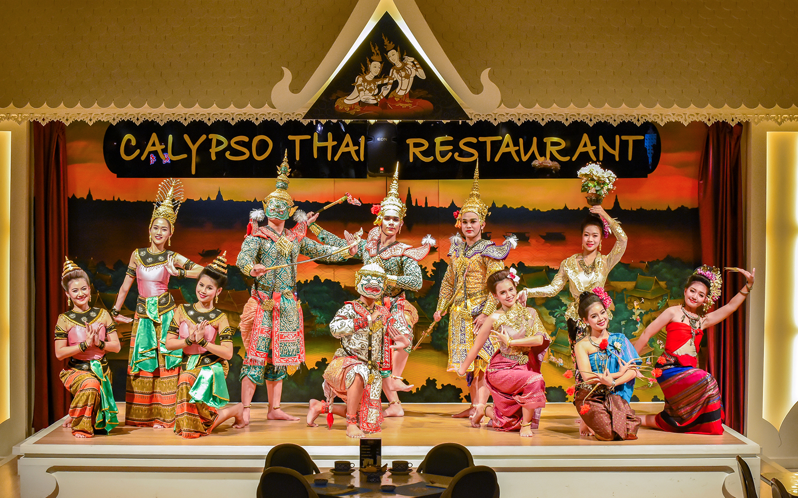 Performers in traditional costumes at Calypso Cabaret dinner show, Bangkok.
