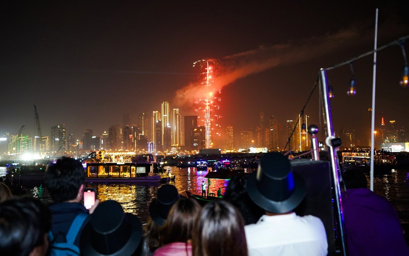 Fireworks over Dubai skyline during New Year's Eve Creek Dhow Dinner Cruise.