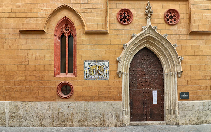 San Nicolas Church ornate wooden door with Gothic arch in Valencia, Spain.