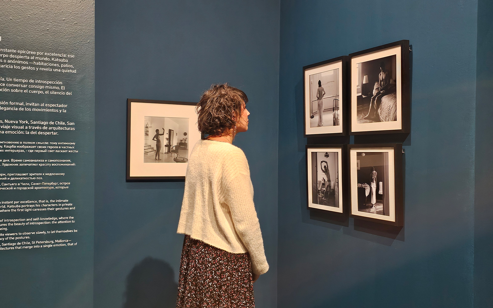 Tourist viewing black-and-white photographs at the Russian Museum exhibition.