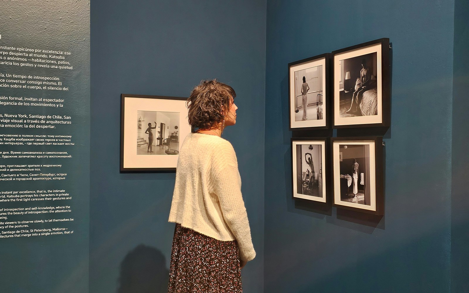 Tourist viewing black-and-white photographs at the Russian Museum exhibition.