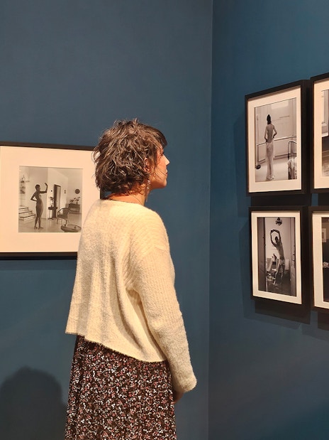 Tourist viewing black-and-white photographs at the Russian Museum exhibition.