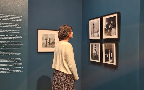Tourist viewing black-and-white photographs at the Russian Museum exhibition.
