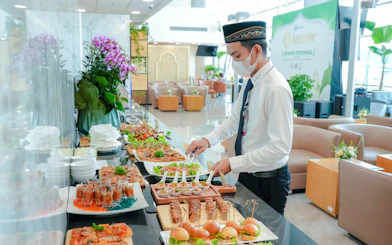 Server preparing buffet at Jasmine Halal Lounge, Terminal 2, Tan Son Nhat International Airport.