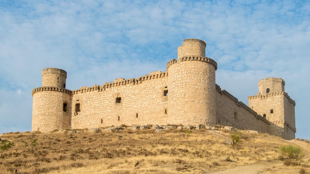 Castillo de Barcience in Spain with stone towers and surrounding countryside.