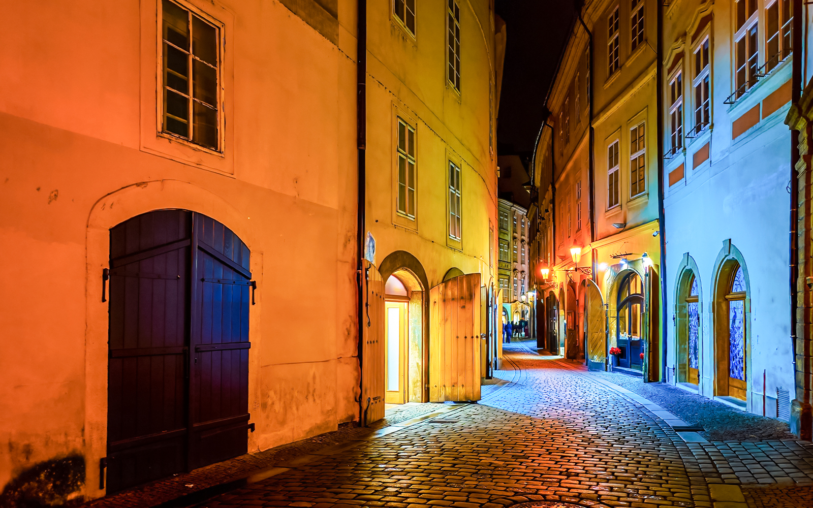 Narrow cobblestone street in Stare Mesto, Prague, lined with historic medieval buildings.