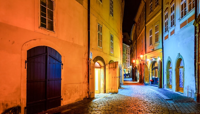 Narrow cobblestone street in Stare Mesto, Prague, lined with historic medieval buildings.