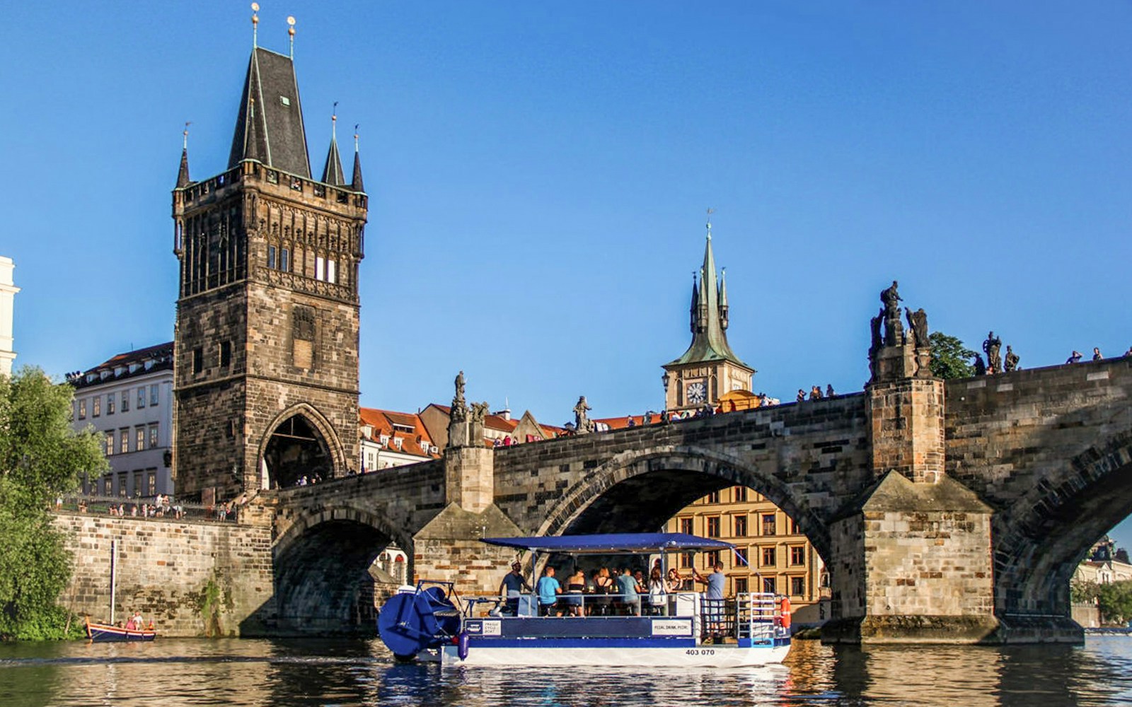 Prague river cruise with tourists enjoying unlimited beer on a scenic boat tour.