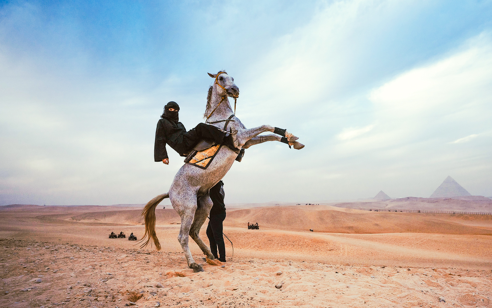 Tourist riding a horse near the Pyramids of Giza in Egypt.