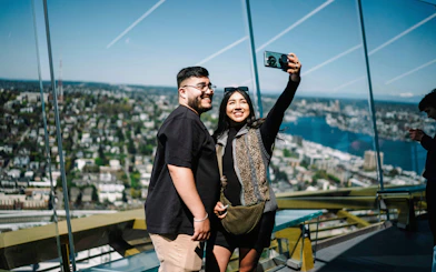 Visitors taking a selfie at the Space Needle observation deck, Seattle.
