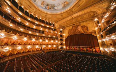 Hungarian State Opera House interior with ornate balconies and stage curtain.
