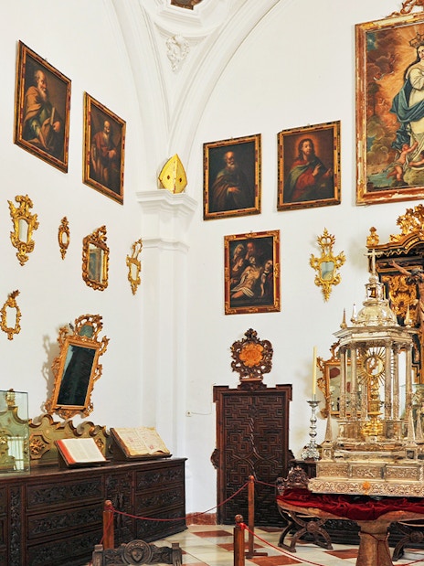 Granada Cathedral Museum interior with religious paintings and ornate artifacts.
