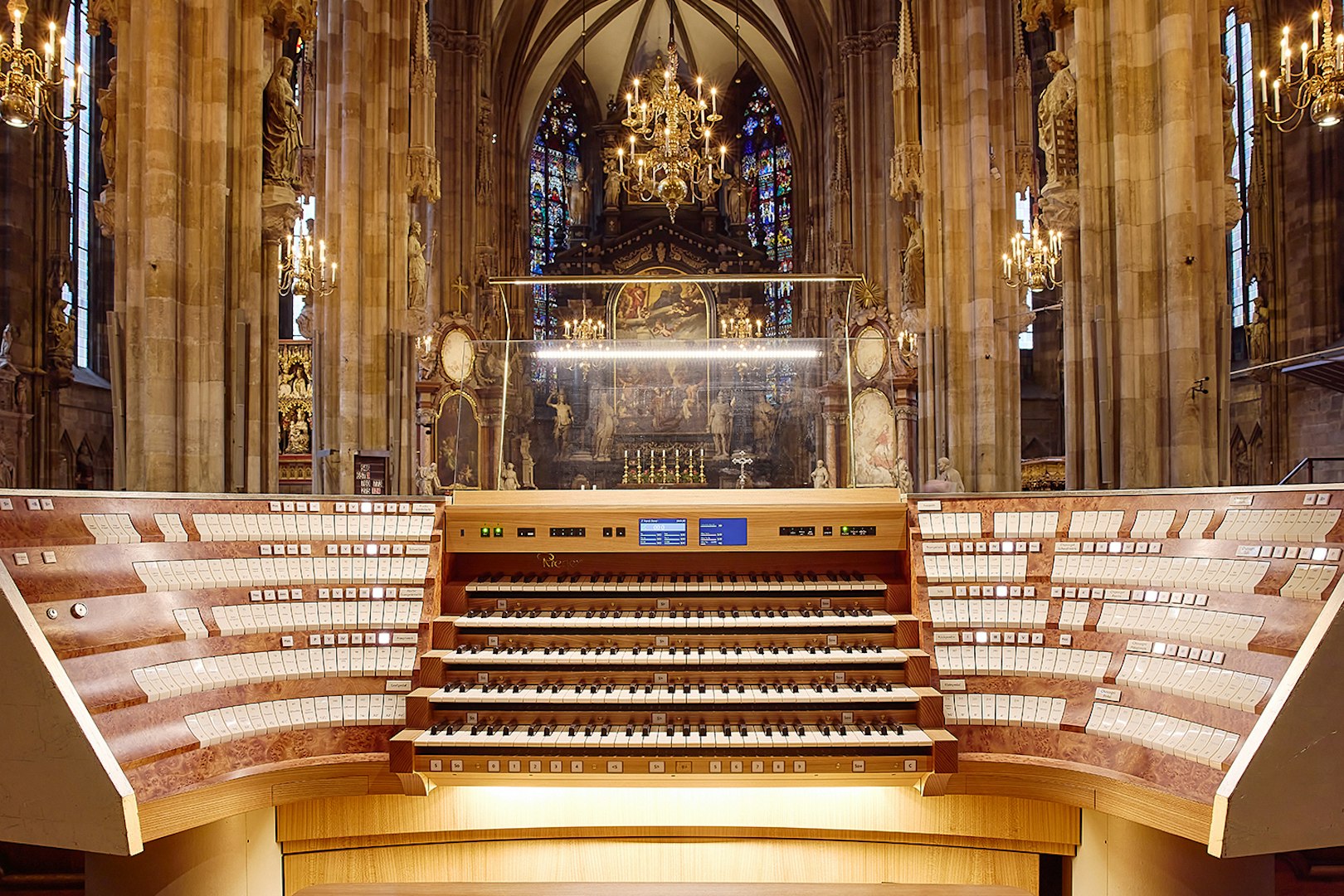 St. Stephen's Cathedral organ console with ornate interior and stained glass windows.