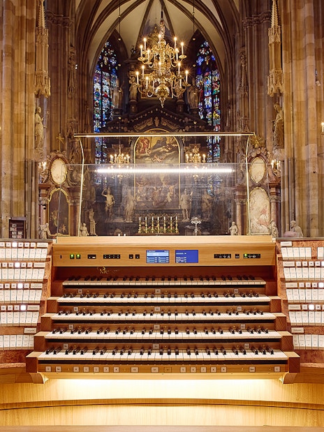 St. Stephen's Cathedral organ console with ornate interior and stained glass windows.