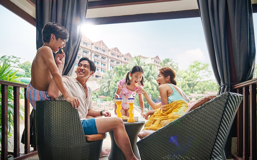 Guests enjoying drinks and snacks at Adventure Cove Waterpark™ cabana.