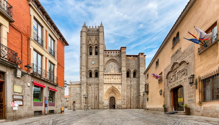Ávila Cathedral facade with surrounding historic buildings in Ávila, Spain.