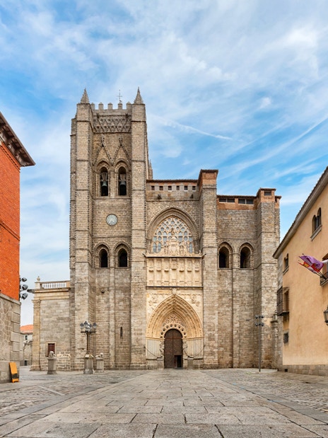 Ávila Cathedral facade with surrounding historic buildings in Ávila, Spain.