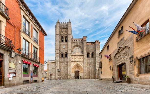 Ávila Cathedral facade with surrounding historic buildings in Ávila, Spain.