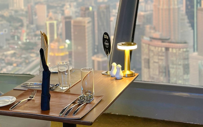 Dining table with city view from Orbit Revolving Restaurant, KL Tower, Kuala Lumpur.