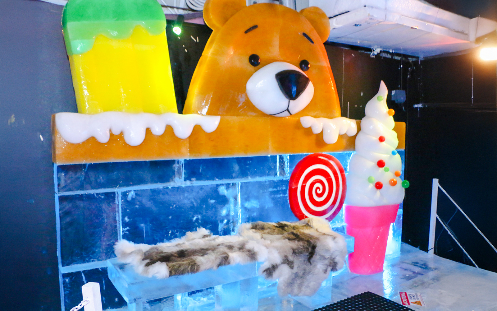 Bear ice sculpture with colorful ice cream and candy at Singapore Snow City.