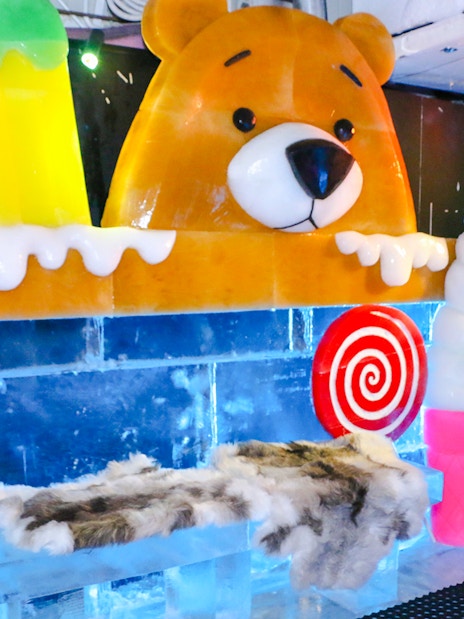 Bear ice sculpture with colorful ice cream and candy at Singapore Snow City.