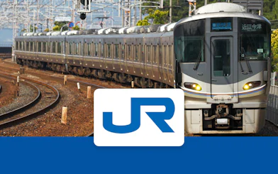 JR train on tracks in Kansai region, Japan, with JR logo in foreground.