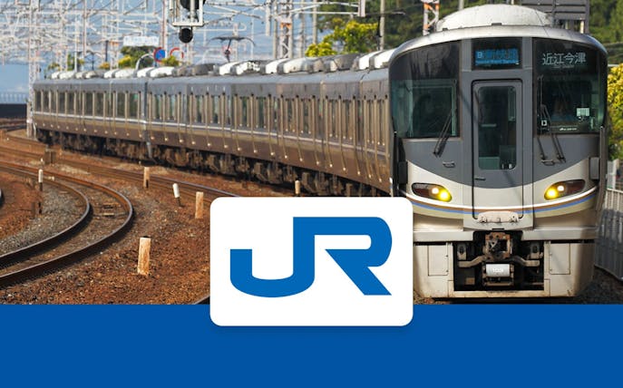 JR train on tracks in Kansai region, Japan, with JR logo in foreground.