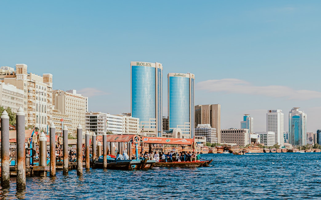Dhow cruise on Dubai Creek with Rolex Towers in the background.