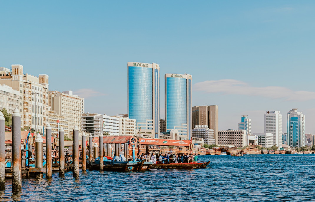Dhow cruise on Dubai Creek with Rolex Towers in the background.