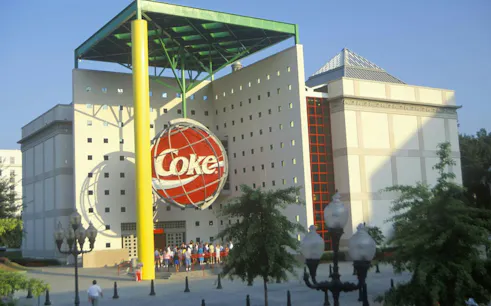 World of Coca-Cola building exterior in Atlanta with visitors gathered outside.